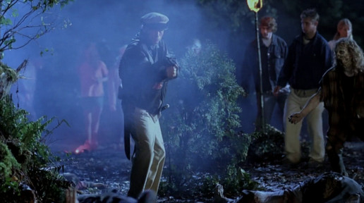 Jürgen Prochnow as Captain Kirk, fires an explosive gun, whilst a zombified extra carefully walks around the other extras who are on the floor. Yet more extras who have neither makeup or costumes can be seen very clearly in the back of the shot.