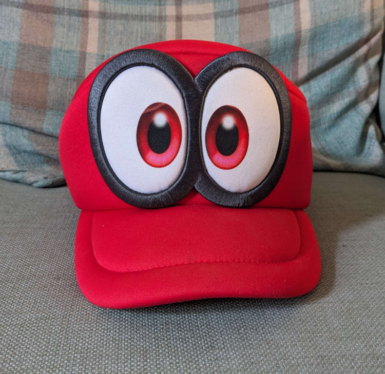 a red Super Mario cap with two very large comic book-style eyes. It is a recreation of Cappy from Super Mario Odyssey